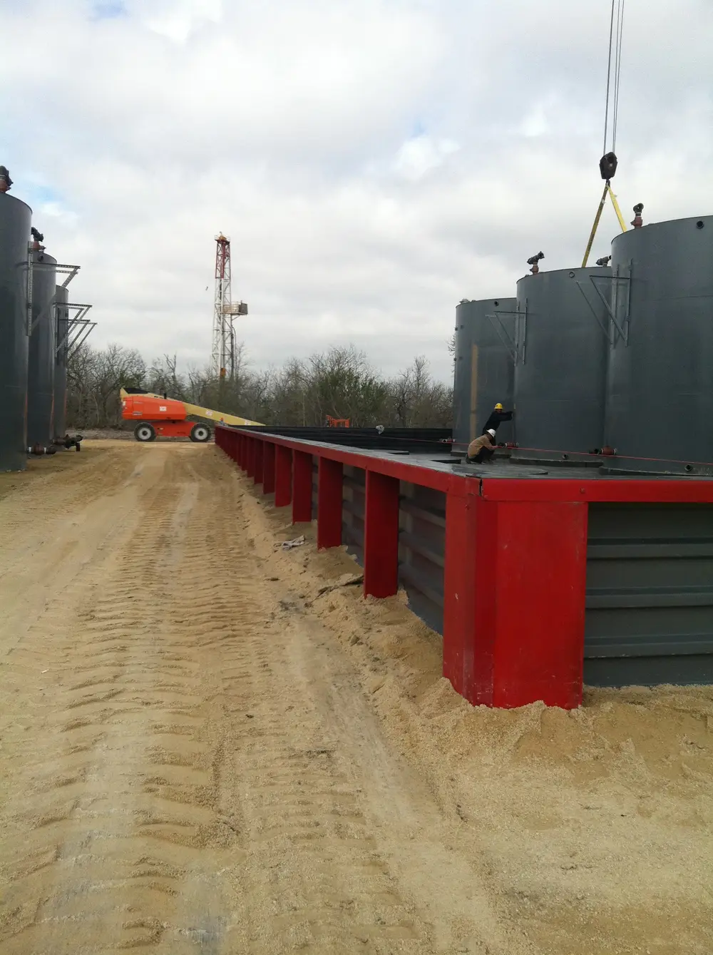 Newly fabricated steel secondary containment structure with corrugated walls