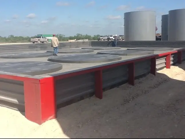 Steel containment berm under construction on a jobsite